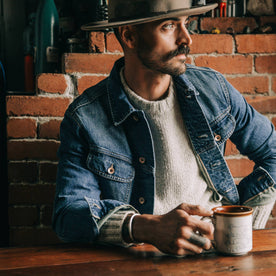 fit model wearing The Long Haul Jacket in 18-Month Wash Organic Selvage, drinking coffee