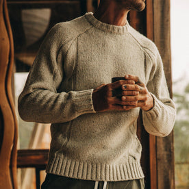 fit model wearing The Topside Sweater in Natural Cable Knit, holding coffee