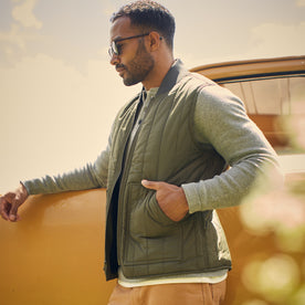 fit model posing in The Able Vest in Quilted Army