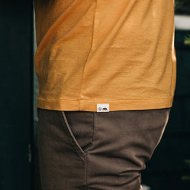 fit model showing the side of The Cotton Hemp Tee in Mustard
