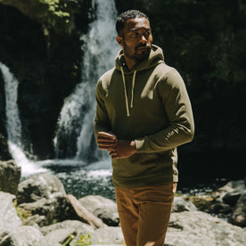 fit model by a waterfall in The Fillmore Hoodie in Cypress Terry