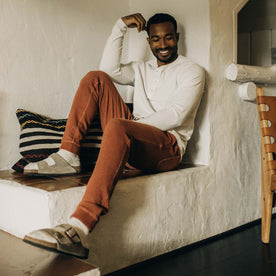 fit model sitting in The Fillmore Pant in Copper Terry