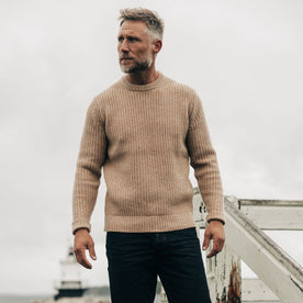 fit model with his hands in his pockets wearing The Fisherman Sweater in Camel