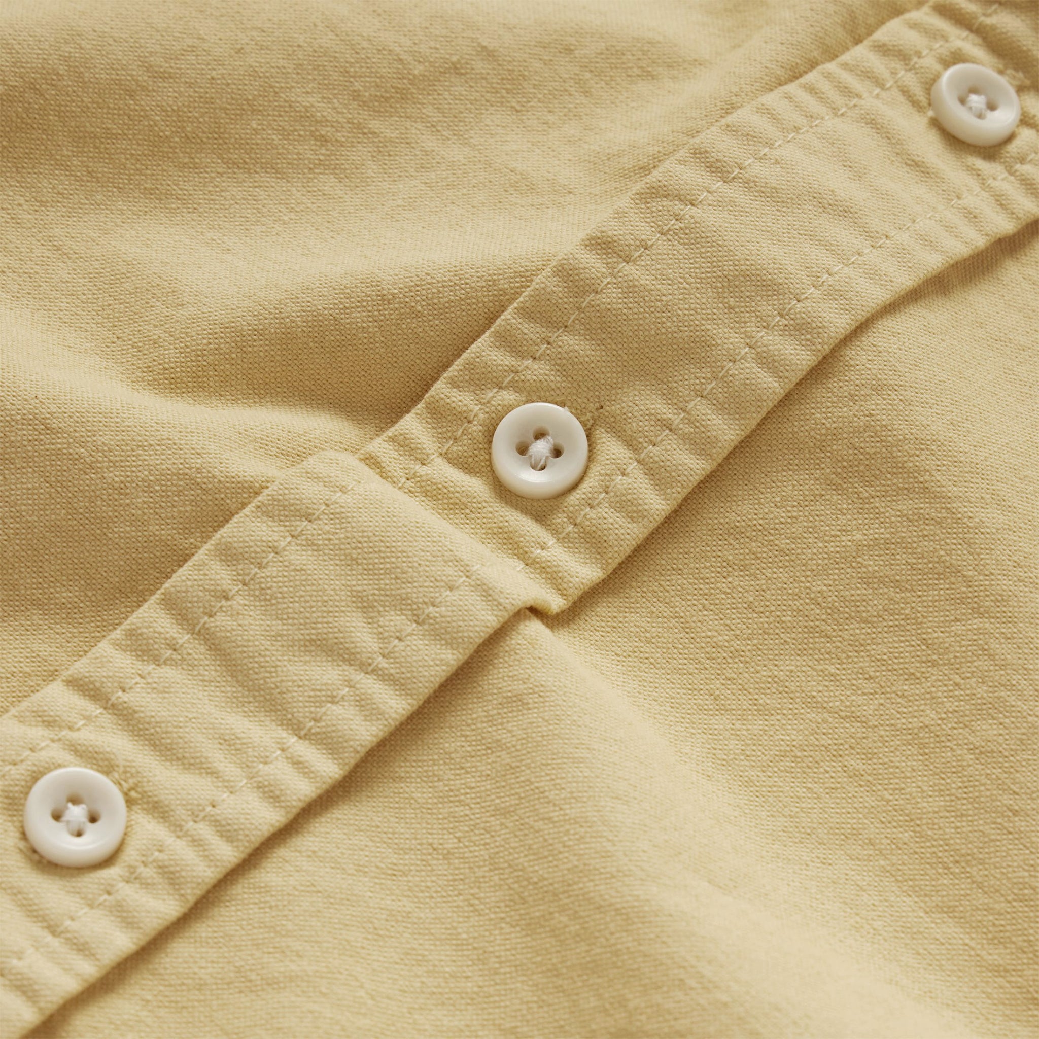 material shot of the buttons on The Jack in Sesame Oxford, Wovens by Taylor Stitch