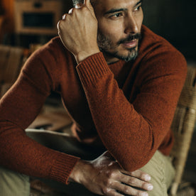 fit model posing wearing The Lodge Sweater in Rust