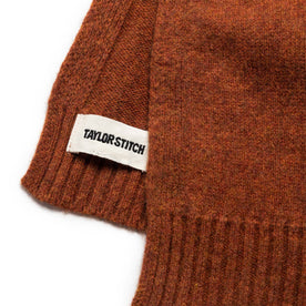 material shot of the label on The Lodge Scarf in Rust