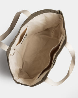 flatlay of The Market Tote in Stone Boss Duck, shown open from the top, Accessories by Taylor Stitch