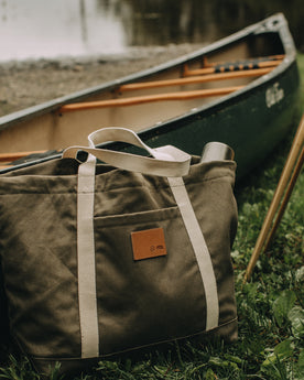 flatlay of The Market Tote in Stone Boss Duck by a lake, Accessories by Taylor Stitch