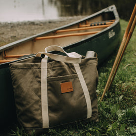 flatlay of The Market Tote in Stone Boss Duck by a lake