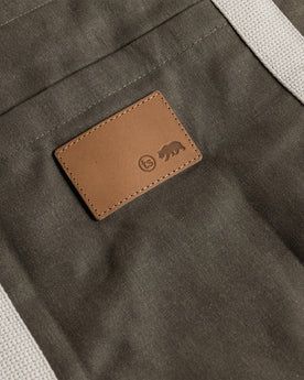 material shot of the leather patch on The Market Tote in Stone Boss Duck, Accessories by Taylor Stitch