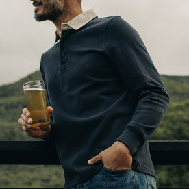 fit model holding a beer in The Rugby Shirt in Dark Navy