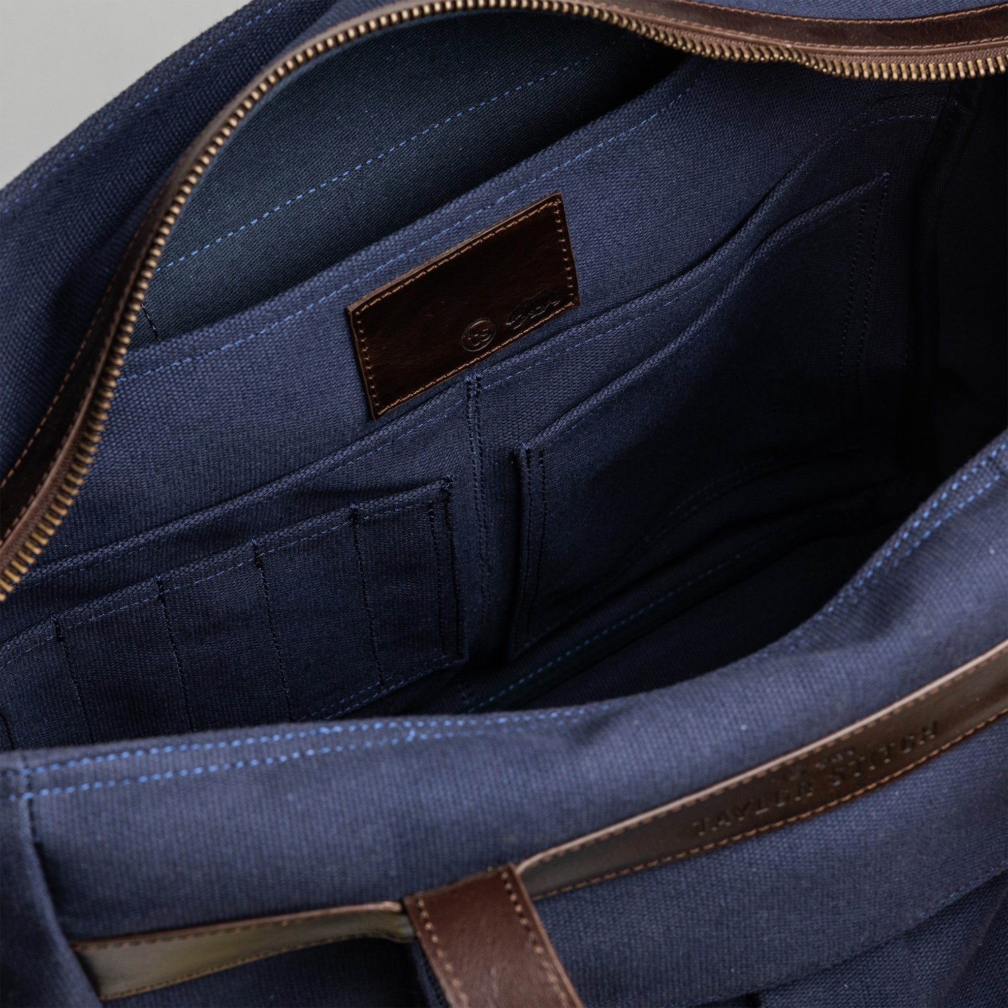 material shot of the internal pockets and pen holder compartments of The Utility Bag in Navy, Accessories by Taylor Stitch