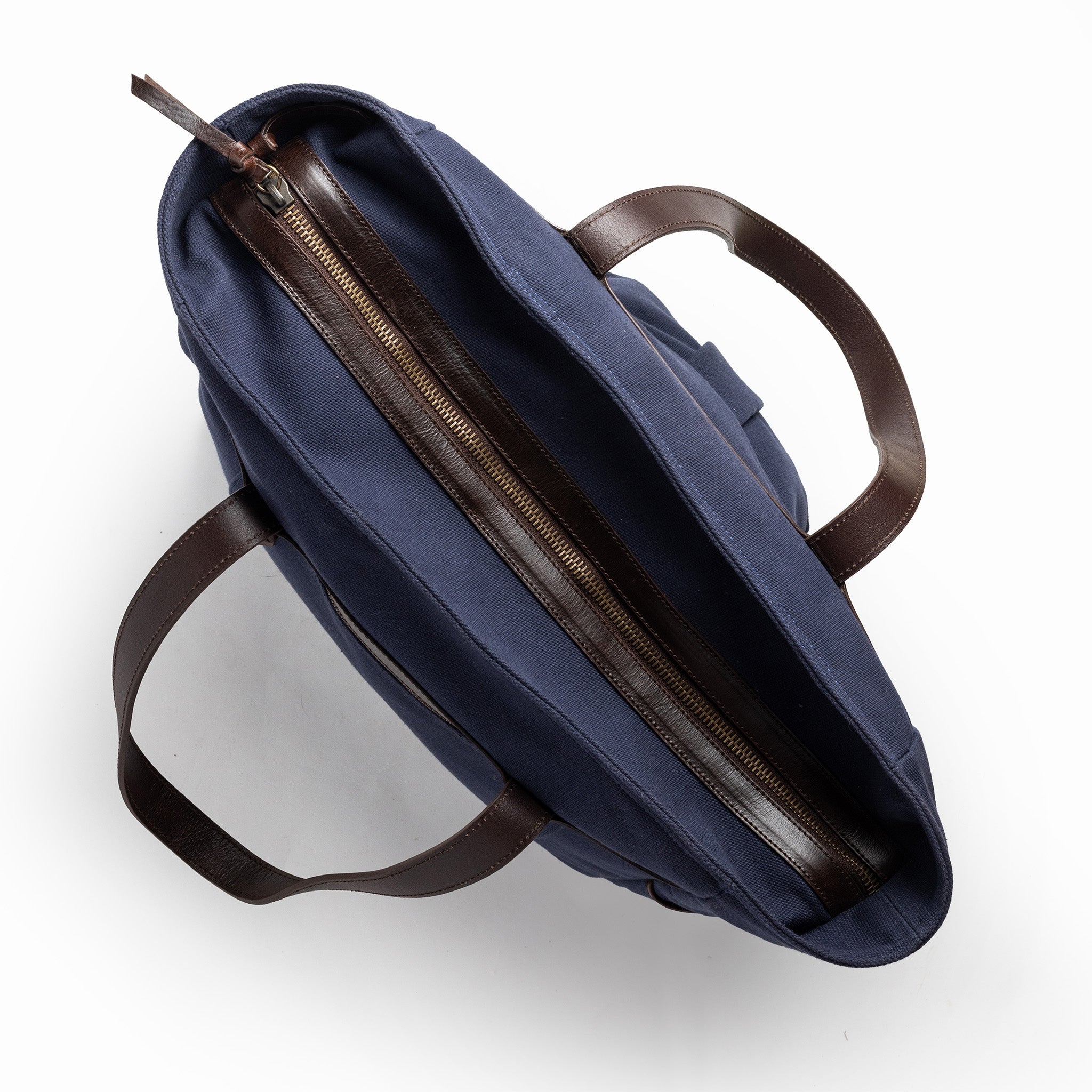 flatlay of The Utility Bag in Navy, shown zipped from the top, Accessories by Taylor Stitch