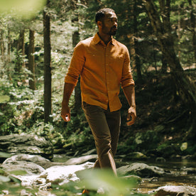 fit model walking through the woods in The Utility Shirt in Russet Double Cloth