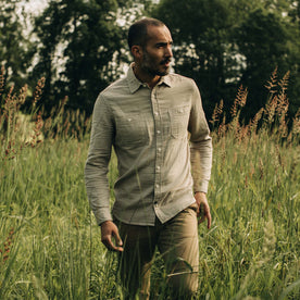 fit model walking in a field in The Utility Shirt in Stone Double Cloth