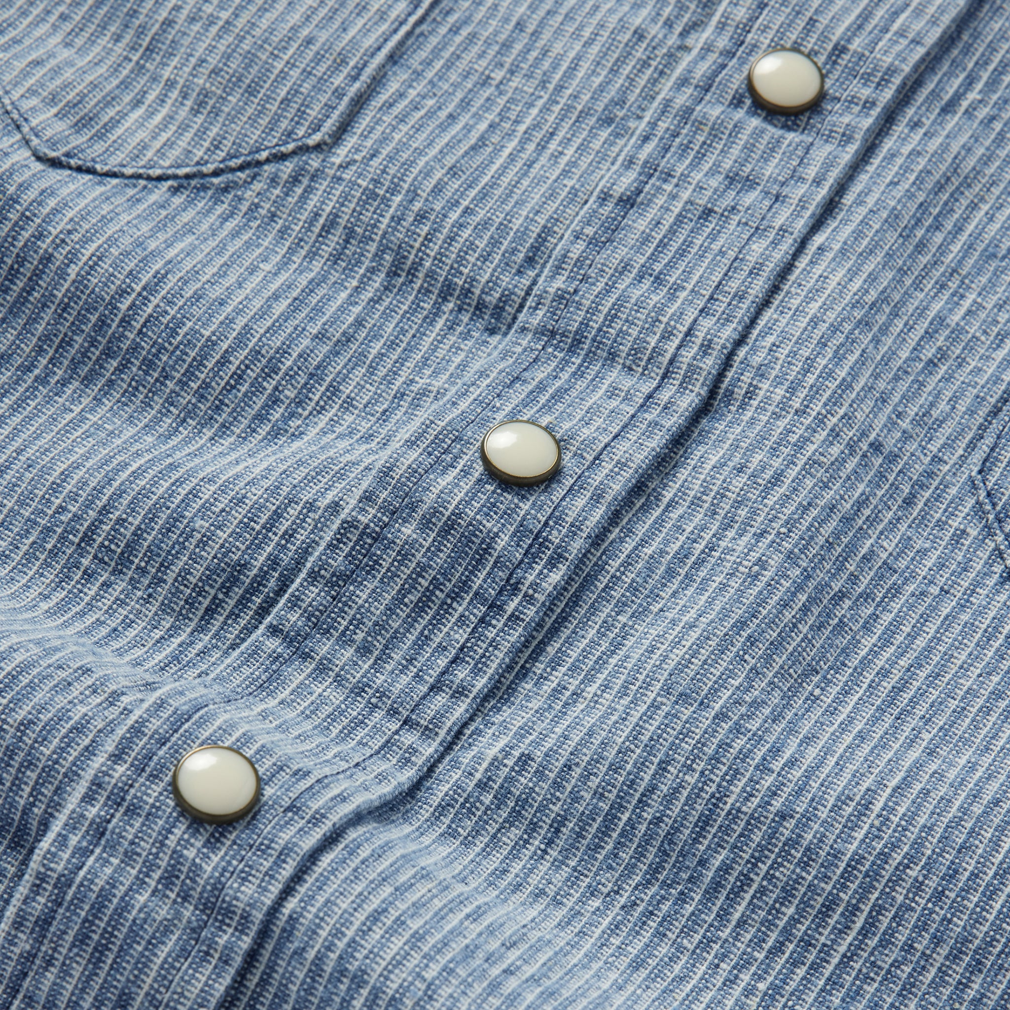 material shot of the buttons on The Western Shirt in Indigo Stripe, Wovens by Taylor Stitch