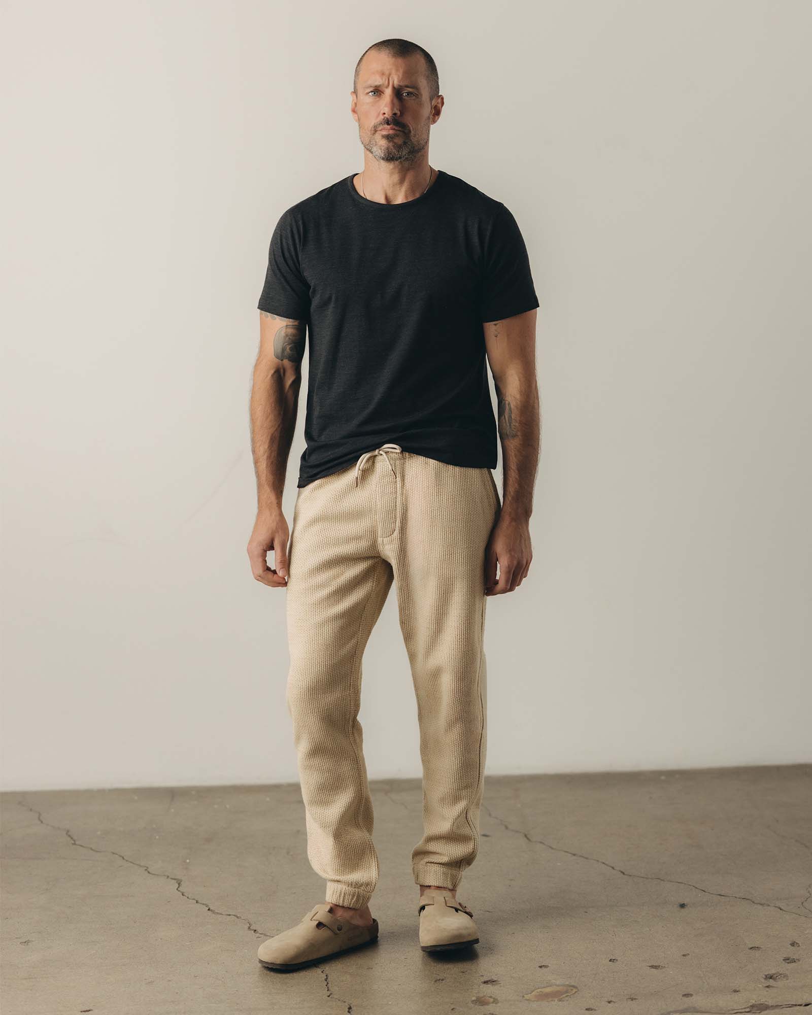 fit model posing in The Apres Pant in Natural Sashiko , Bottoms by Taylor Stitch