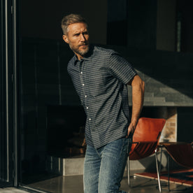 fit model standing in a house wearing The Short Sleeve Hawthorne in Navy Dobby