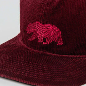 material shot of The Ball Cap in Burgundy Cord showing bear