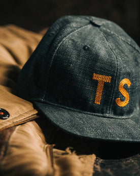 material shot of The Ball Cap in Organic Denim on a table, Accessories by Taylor Stitch