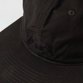 material shot of The Ball Cap in Espresso Dry Wax showing bear
