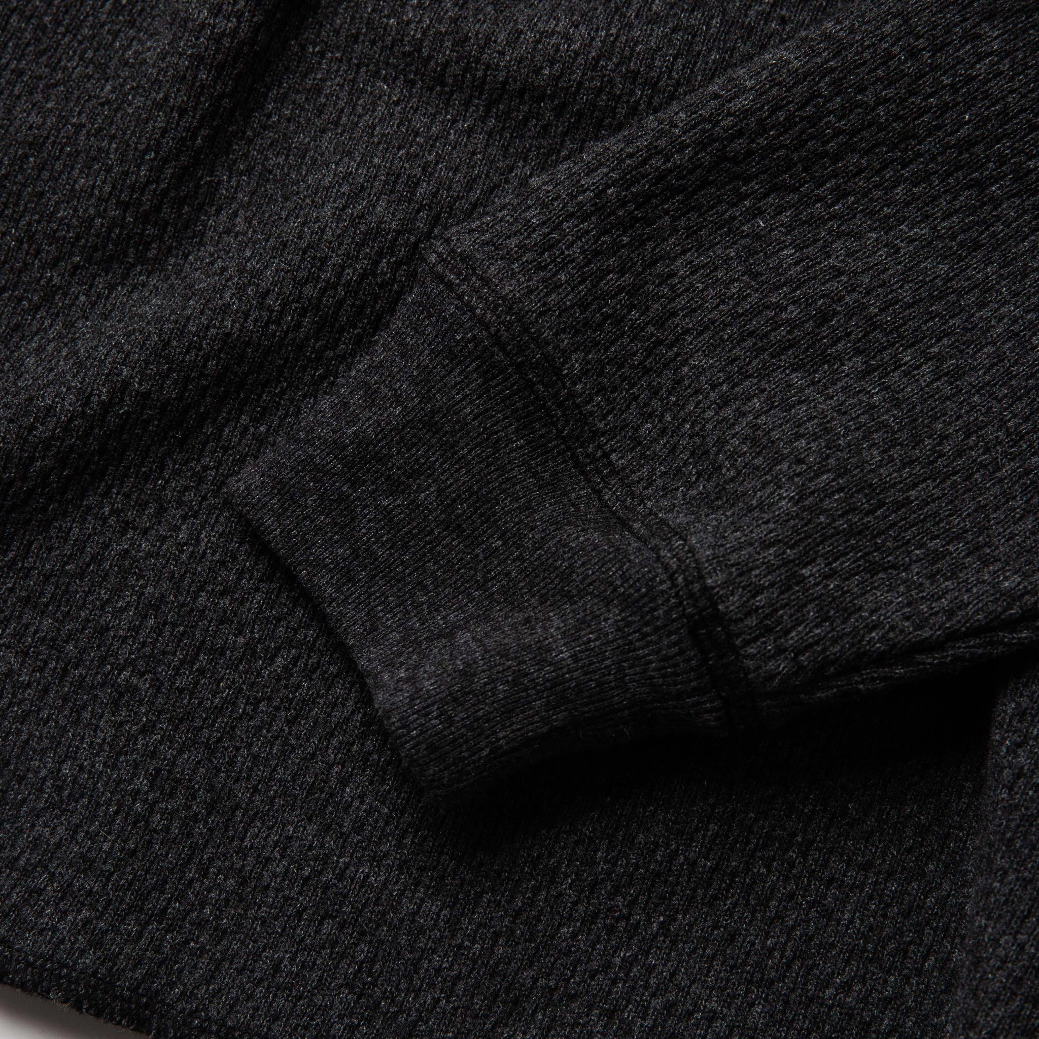 material shot of sleeve cuff of The Heavy Bag Waffle Henley in Coal, Knits by Taylor Stitch