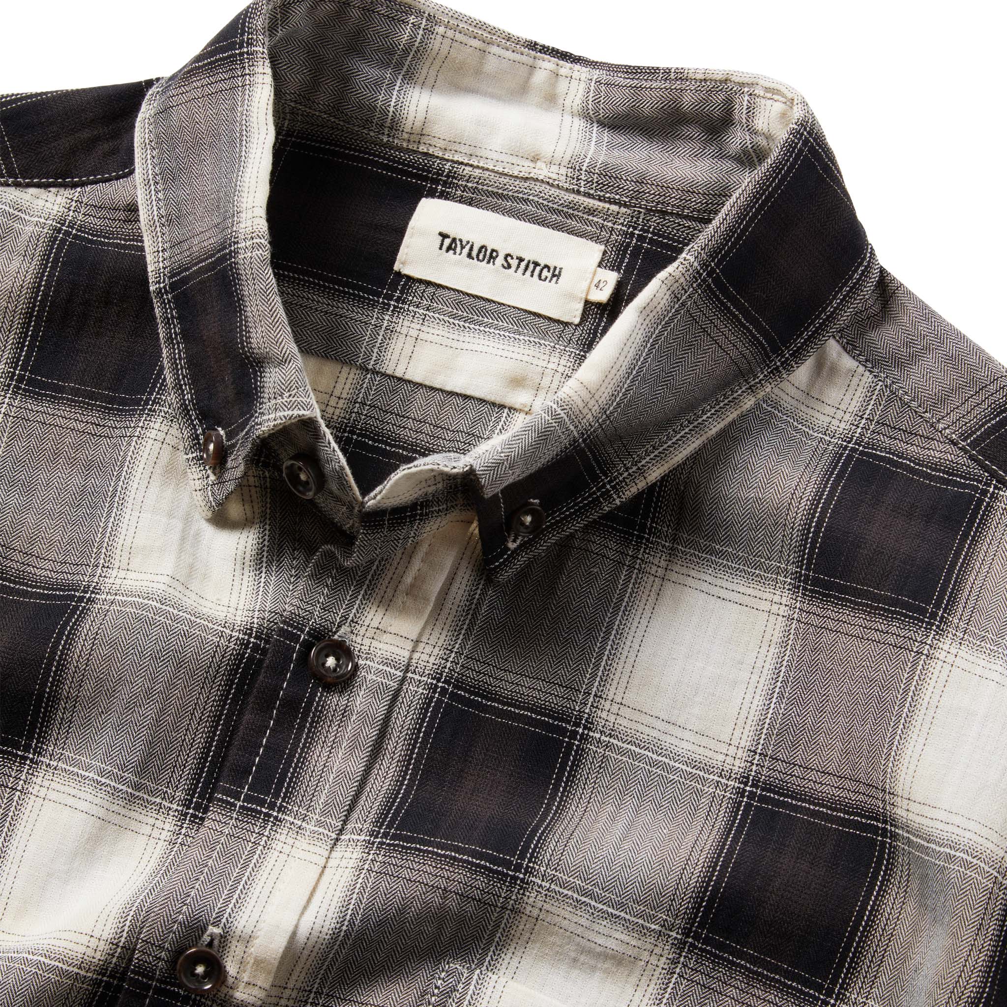 material shot of The Jack in Coal Herringbone Check from the front showing label, Wovens by Taylor Stitch