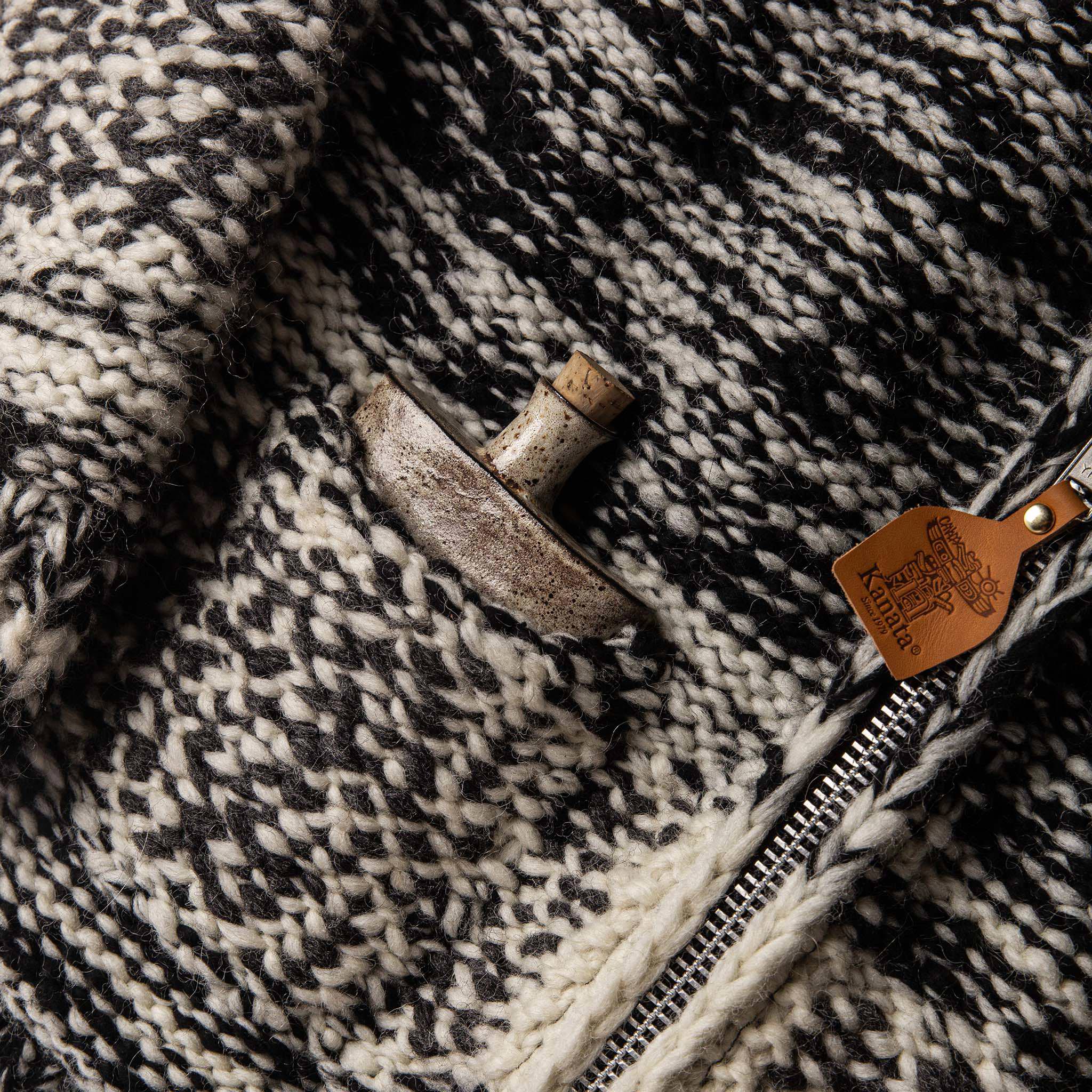 material shot of The Seawall Hand-knit Sweater with a flask in the exterior pocket, Knits by Taylor Stitch