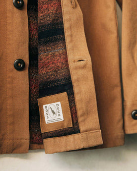 material shot of boss duck logo, Outerwear by Taylor Stitch