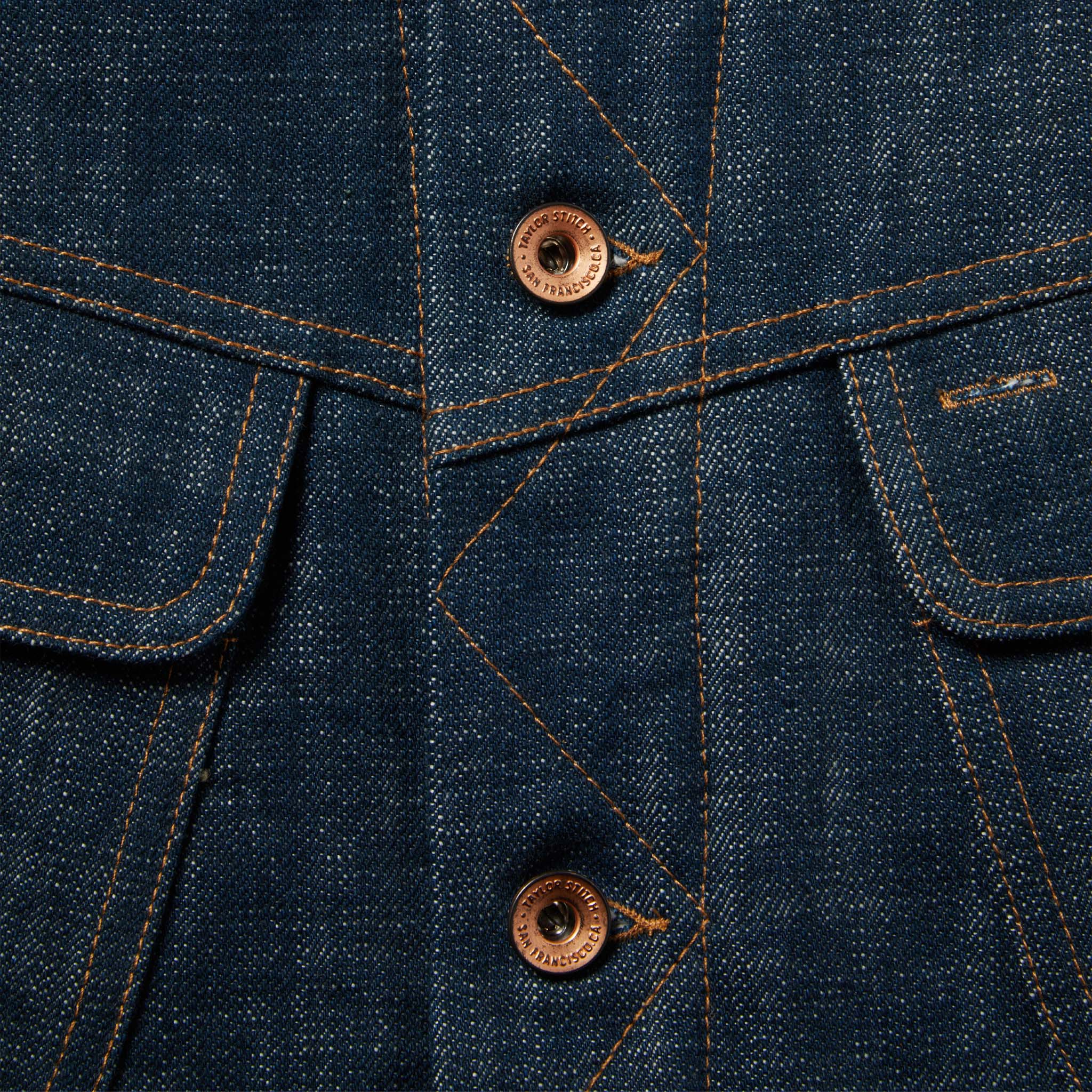 material shot of The Lined Long Haul Jacket in Green Cast Denim showing placket and buttons, Outerwear by Taylor Stitch