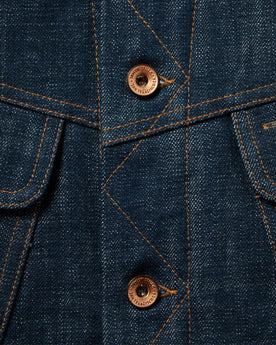 material shot of The Lined Long Haul Jacket in Green Cast Denim showing placket and buttons, Outerwear by Taylor Stitch