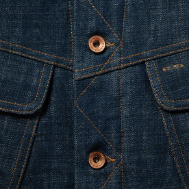 material shot of The Lined Long Haul Jacket in Green Cast Denim showing placket and buttons