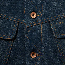material shot of The Lined Long Haul Jacket in Green Cast Denim showing placket and buttons