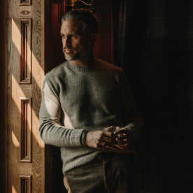 fit model wearing the lodge sweater, looking left