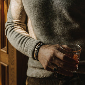 fit model wearing the lodge sweater, holding drink