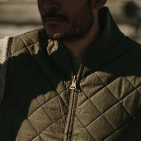 Fit model wearing The Quilted Bomber Vest in Olive Dry Wax with close up of collar