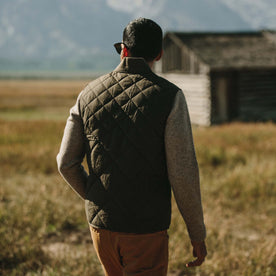 Fit model wearing The Quilted Bomber Vest in Olive Dry Wax showing back