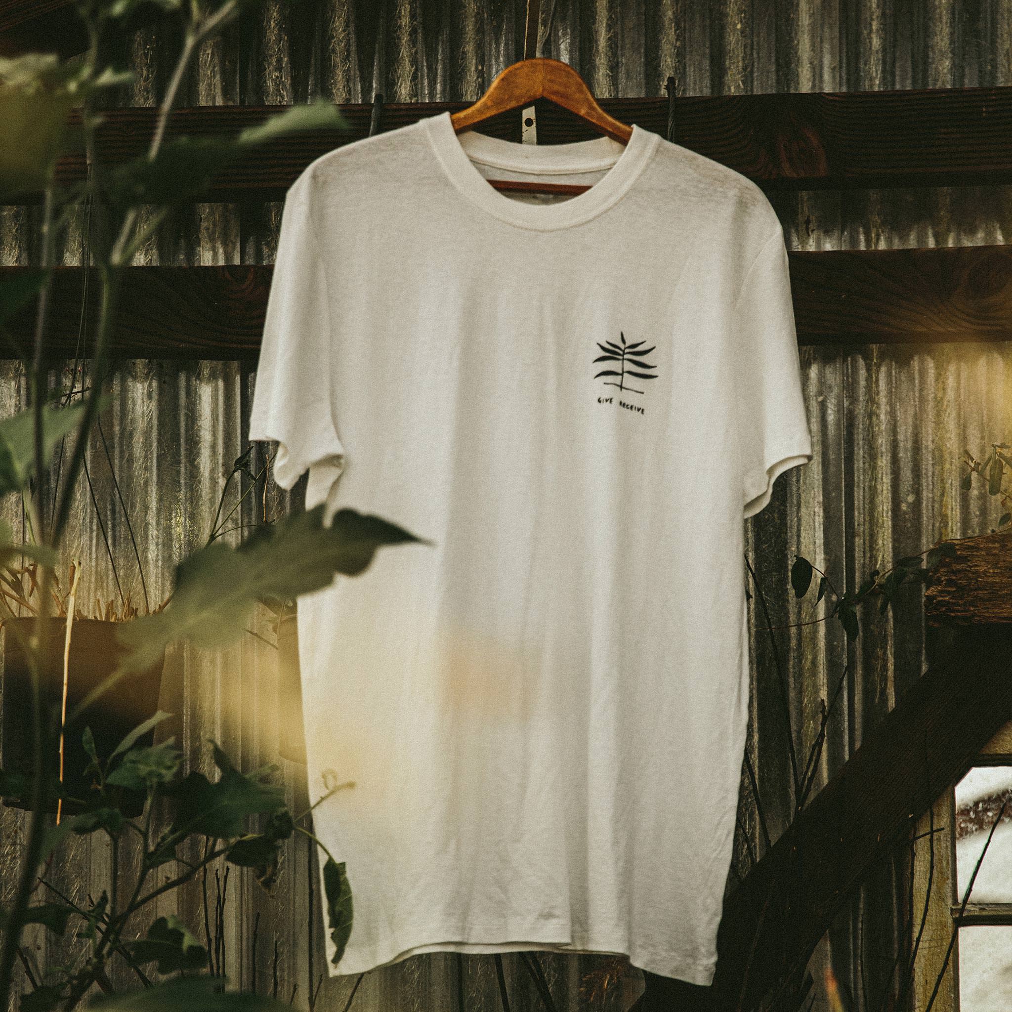 material shot of The Cotton Hemp Tee in Natural Give to Get, hanging, Knits by Taylor Stitch