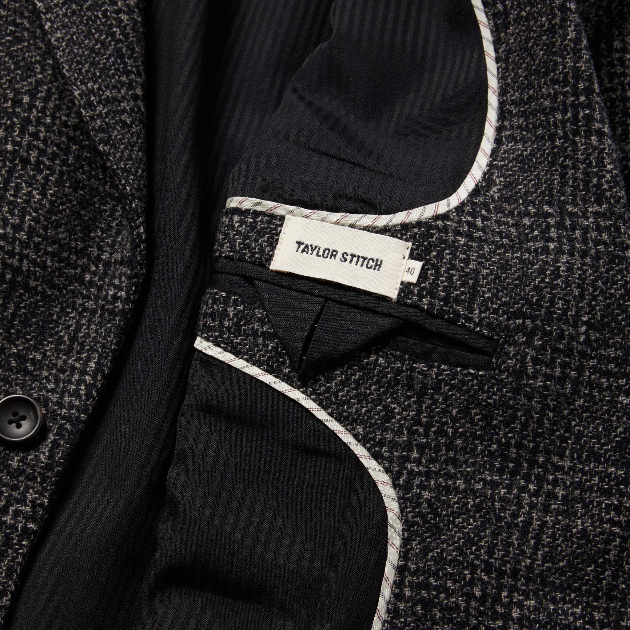material shot of The Sheffield Sportcoat in Coal Slub Check showing tailors mark and pocket and french piping, Outerwear by Taylor Stitch