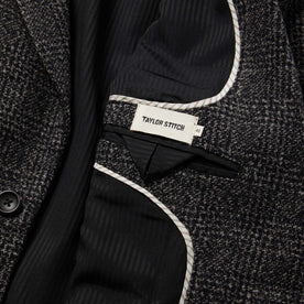 material shot of The Sheffield Sportcoat in Coal Slub Check showing tailors mark and pocket and french piping