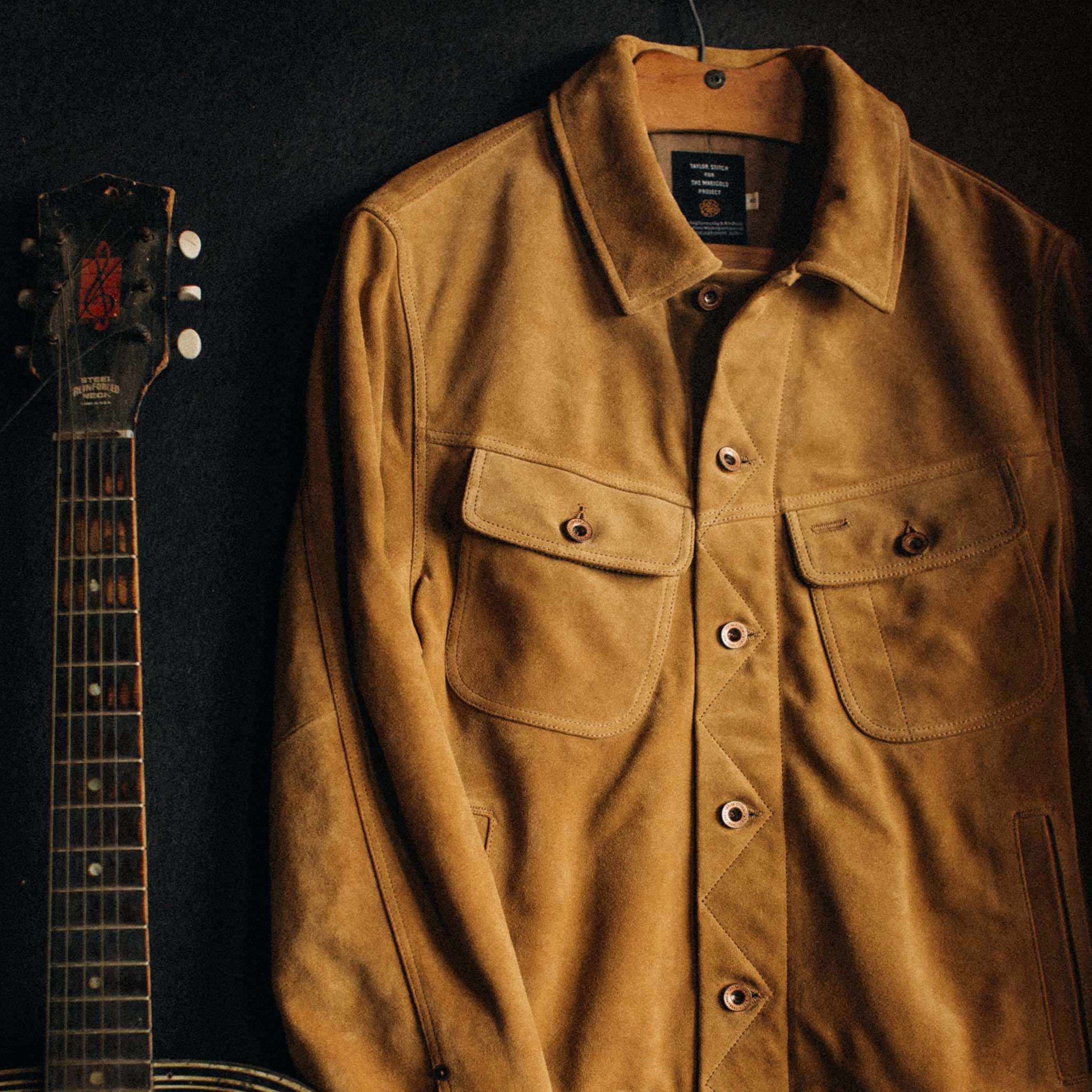 material shot of The Lined Long Haul Jacket in Sand Suede hanging up, Outerwear by Taylor Stitch