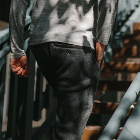 fit model wearing The Weekend Pant in Charcoal Herringbone Wool walking up the steps