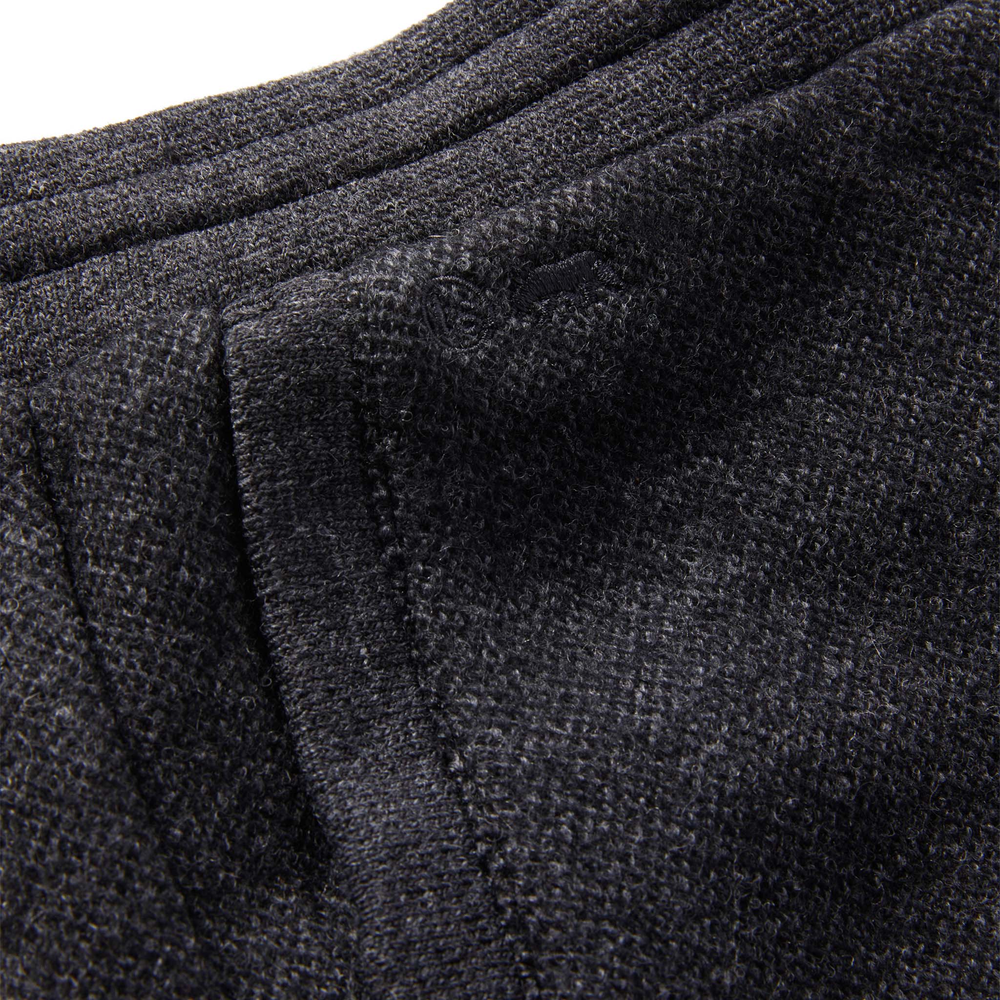 material shot of The Weekend Pant in Charcoal Herringbone Wool showing TS logo embroidery , Bottoms by Taylor Stitch
