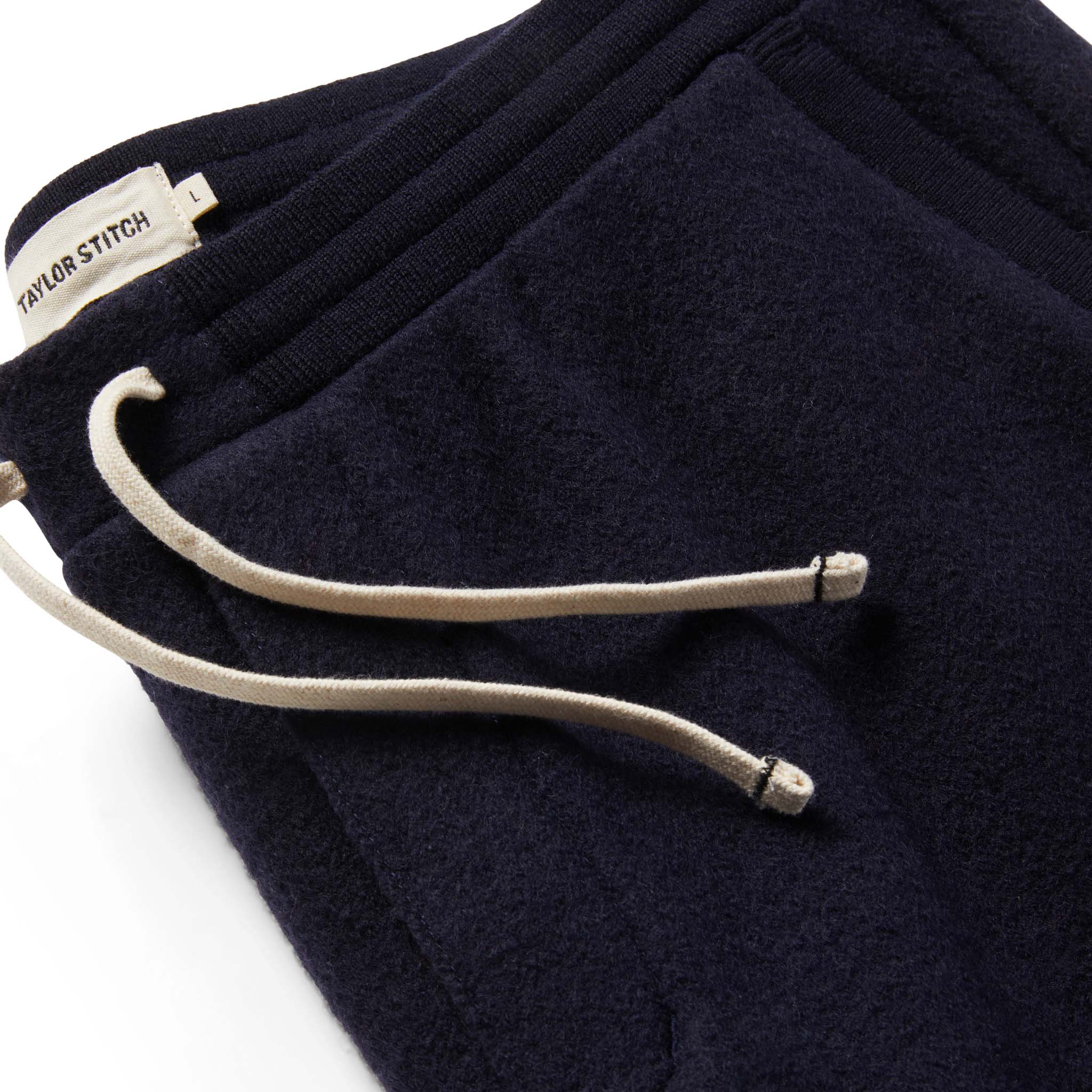 Material shot of The Weekend Pant in Navy Boiled Wool showing drawstrings, Bottoms by Taylor Stitch