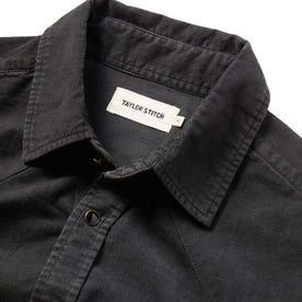 material shot of the shirt with the collar open and showing the tag
