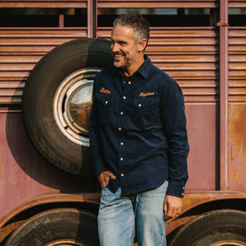 fit model wearing The Western Shirt in Better Together leaning up against a tire