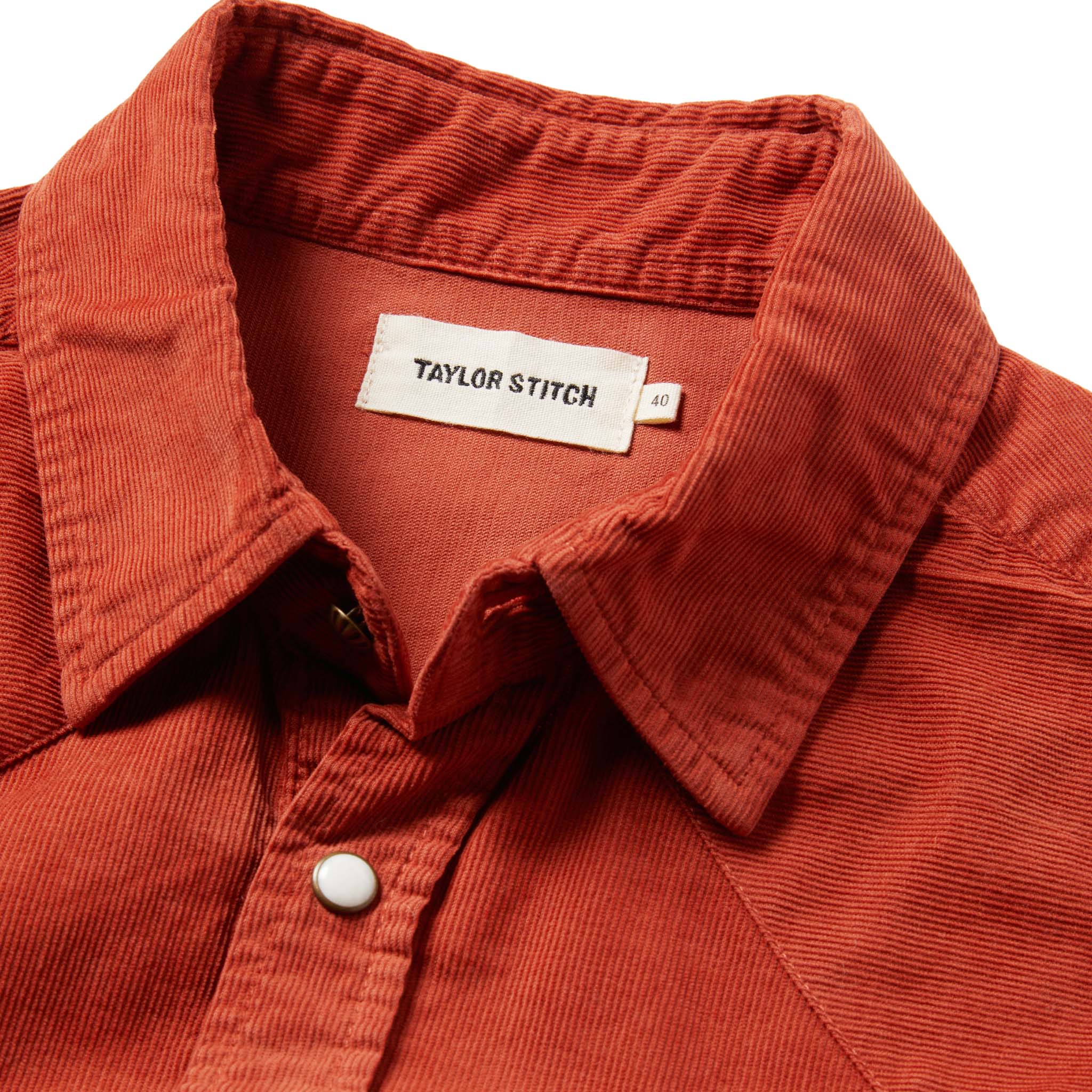 material shot of the shirt with the collar up close, unbuttoned, with the tag visible, Wovens by Taylor Stitch