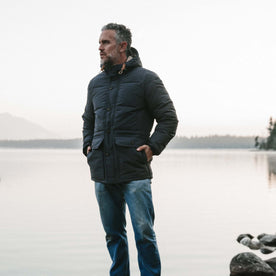fit model wearing The Whitney Parka in Navy in front of a lake