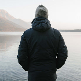 fit model wearing The Whitney Parka in Navy looking out over a lake in Wyoming