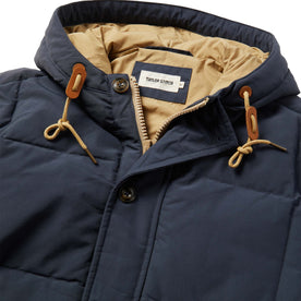 material shot of The Whitney Parka in Navy with a close up of the hood